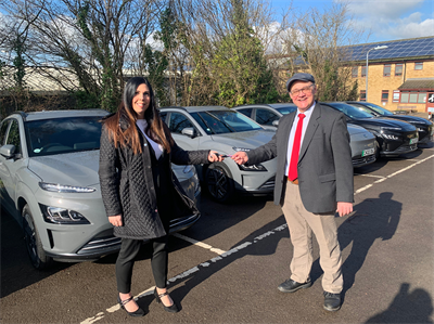 Cllr King accepts keys for new electric vehicles from Helen Walker of Wessex Garage